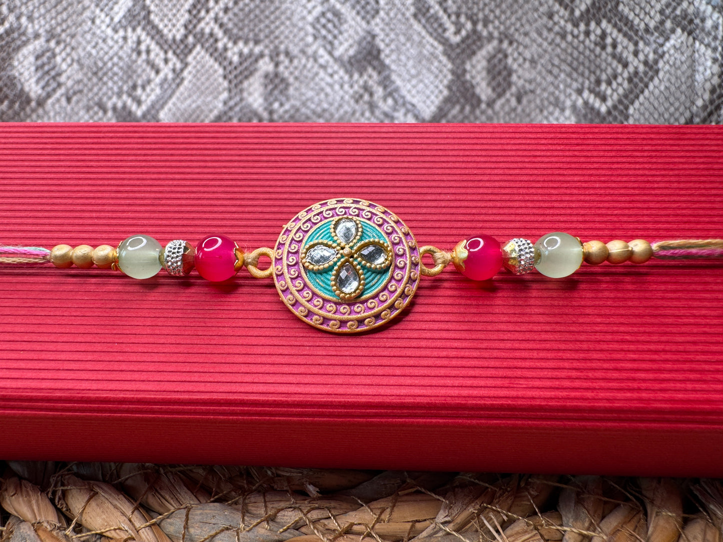 Pastel Bloom Rakhi with Floral Centerpiece – Elegant & Colorful Charm