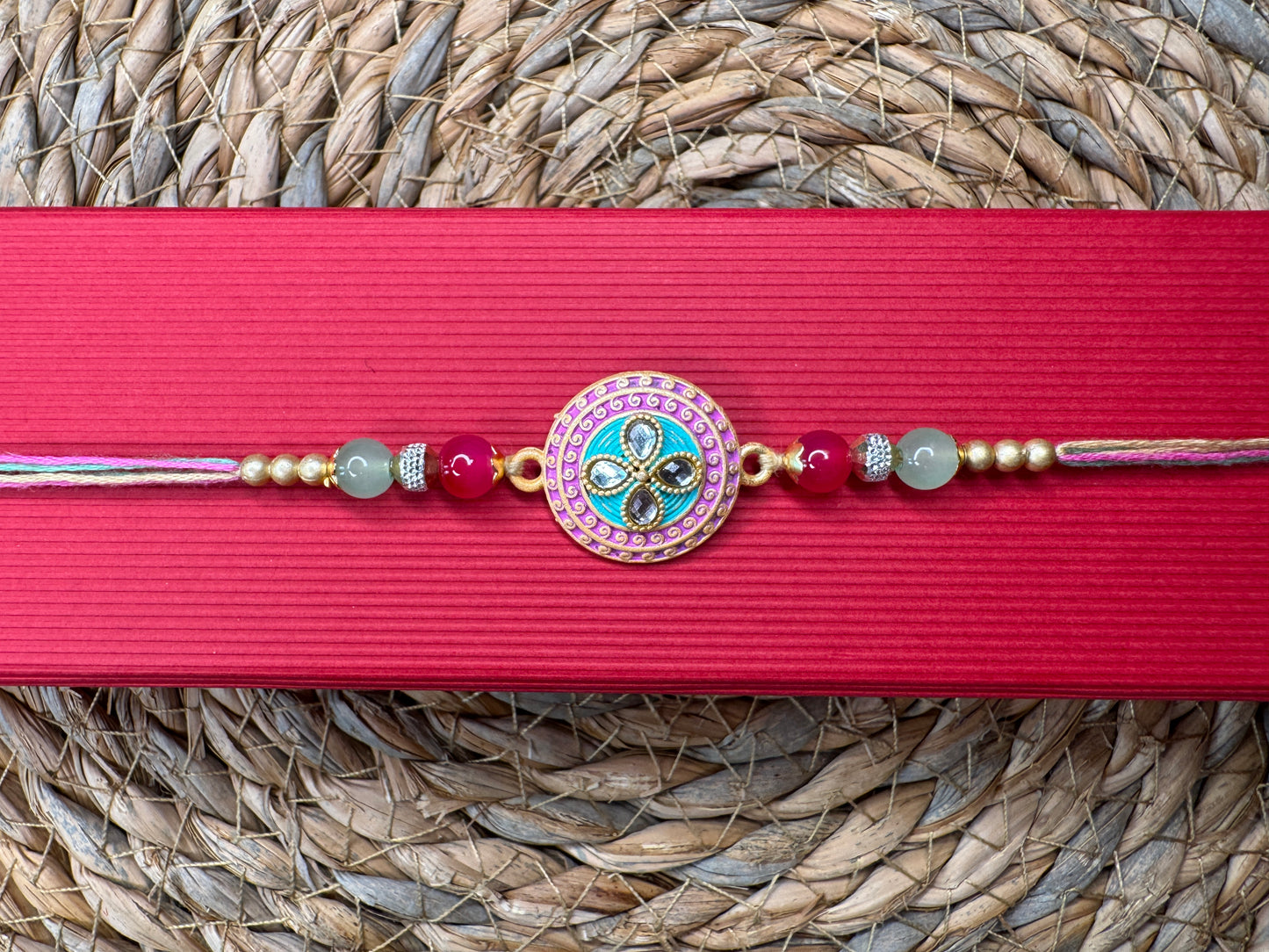 Pastel Bloom Rakhi with Floral Centerpiece – Elegant & Colorful Charm